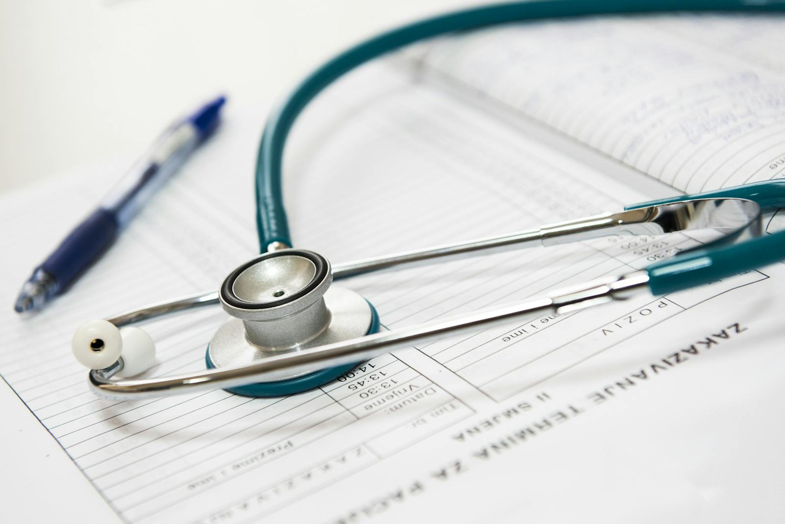 What You Should Know Before Treatment 1 A stethoscope and pen resting on a medical report in a healthcare setting.